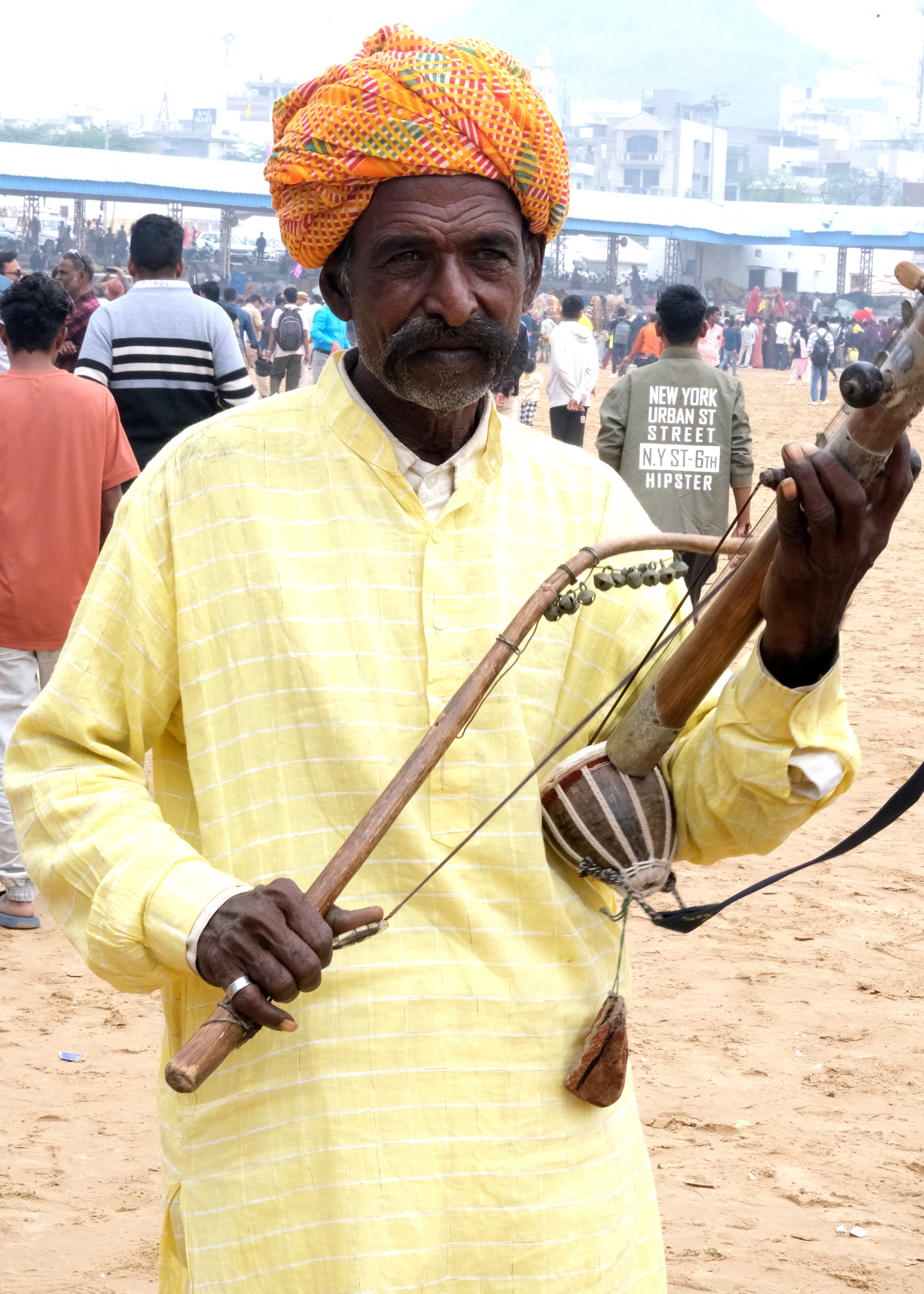 A Village person has been playing with his instrument